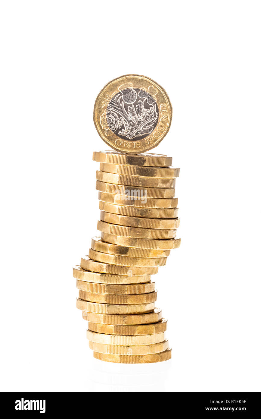 UK British Pound coin on top of stack of coins with white background Stock Photo