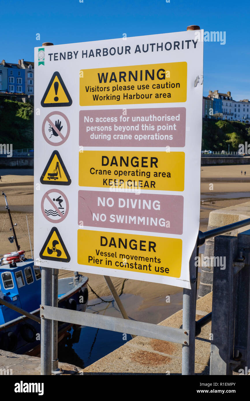 WARNING SIGN ON HARBOUR WALL TENBY PEMBROKESHIRE Stock Photo