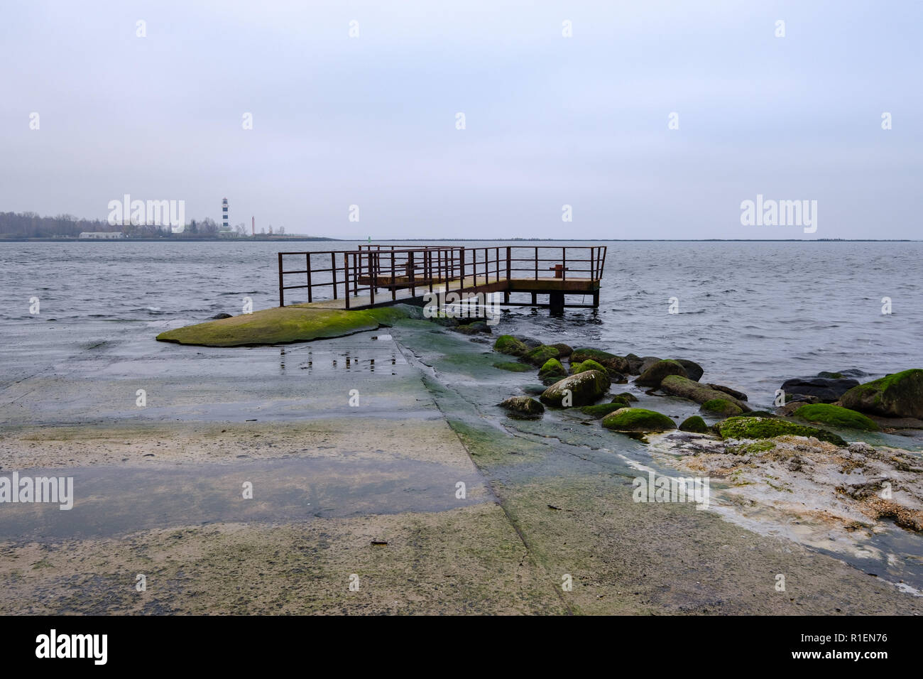 breakwater in sea with old metal railing port dock in empty autumn ...