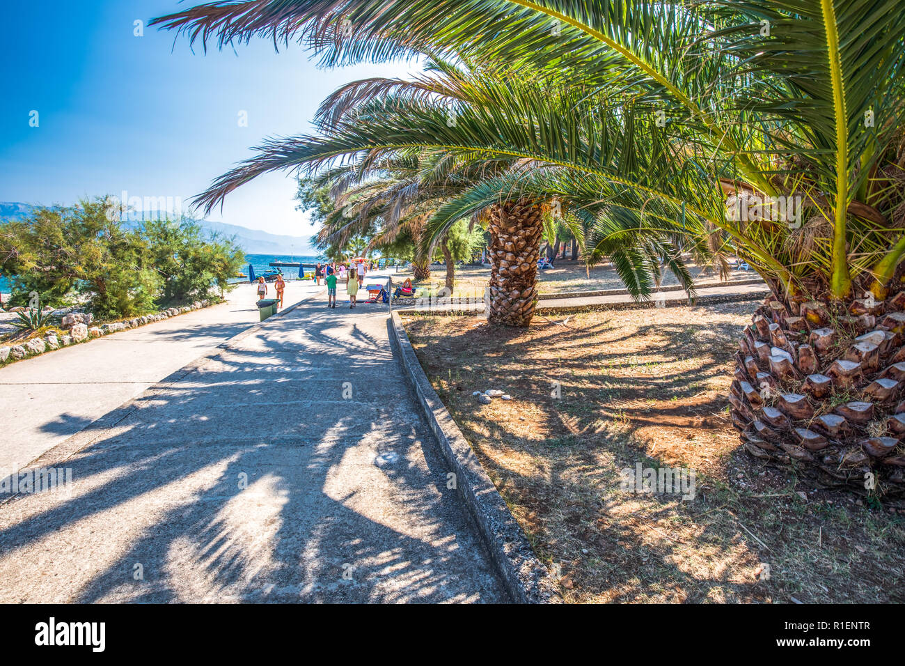 BRAC, CROATIA - August 6, 2018 - Stone beach on Brac island with turquoise clear ocean water, Supetar, Brac, Croatia Stock Photo