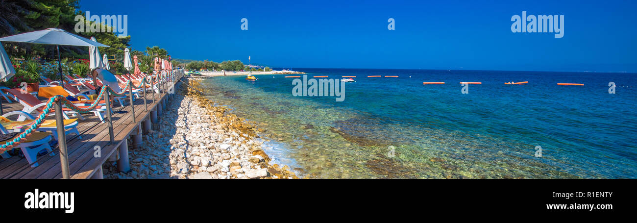 BRAC, CROATIA - August 6, 2018 - Stone beach on Brac island with turquoise clear ocean water, Supetar, Brac, Croatia Stock Photo