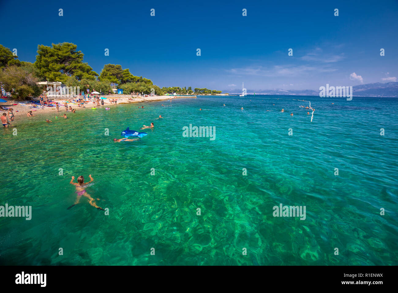 BRAC, CROATIA - August 6, 2018 - Pebble beach on Brac island with turquoise clear ocean water, Supetar, Brac, Croatia Stock Photo