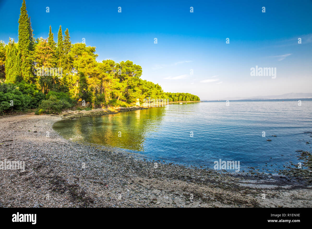 Pebble beach on Brac island with turquoise clear ocean water, Supetar, Brac, Croatia Stock Photo