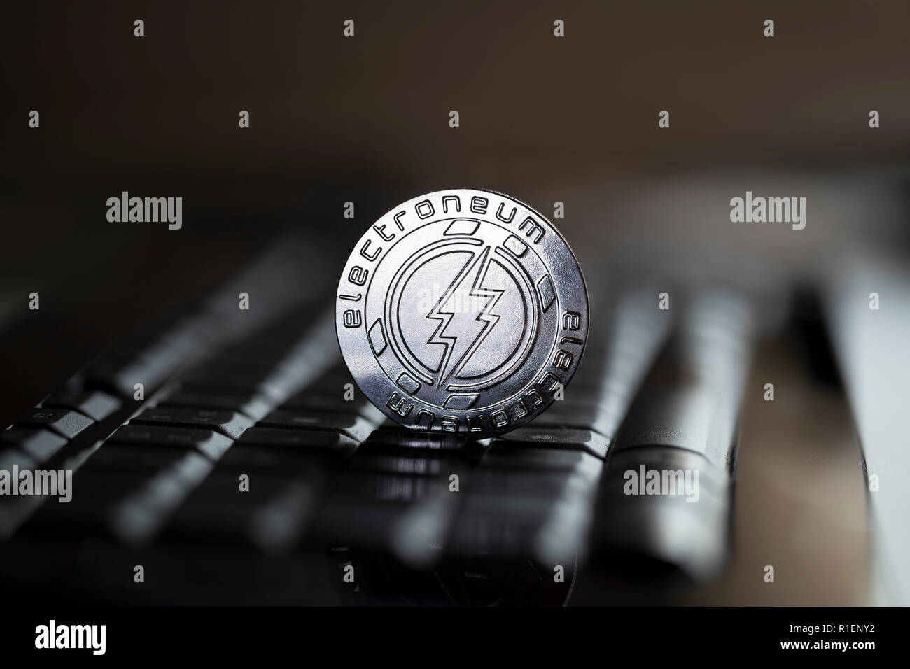 Electroneum cryptocurrency physical coin placed on the computer keyboard Stock Photo