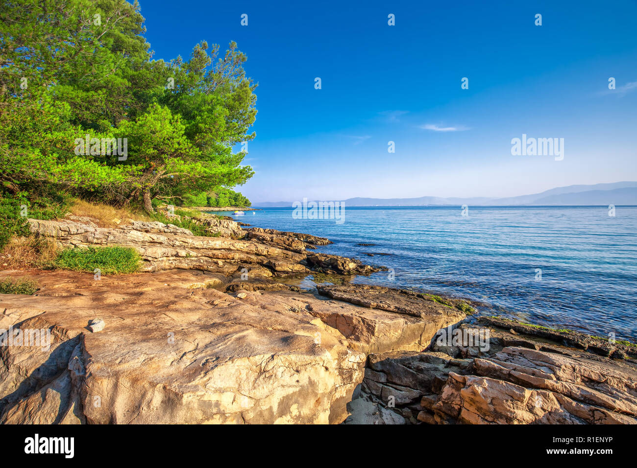 Stone beach on Brac island with turquoise clear ocean water, Supetar, Brac, Croatia Stock Photo