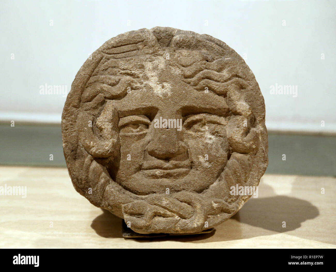 Carved stone depicting a Medusa-head. 1st - 2nd centuries AD. Roman art, Barcino. Barcelona. MAC. Stock Photo