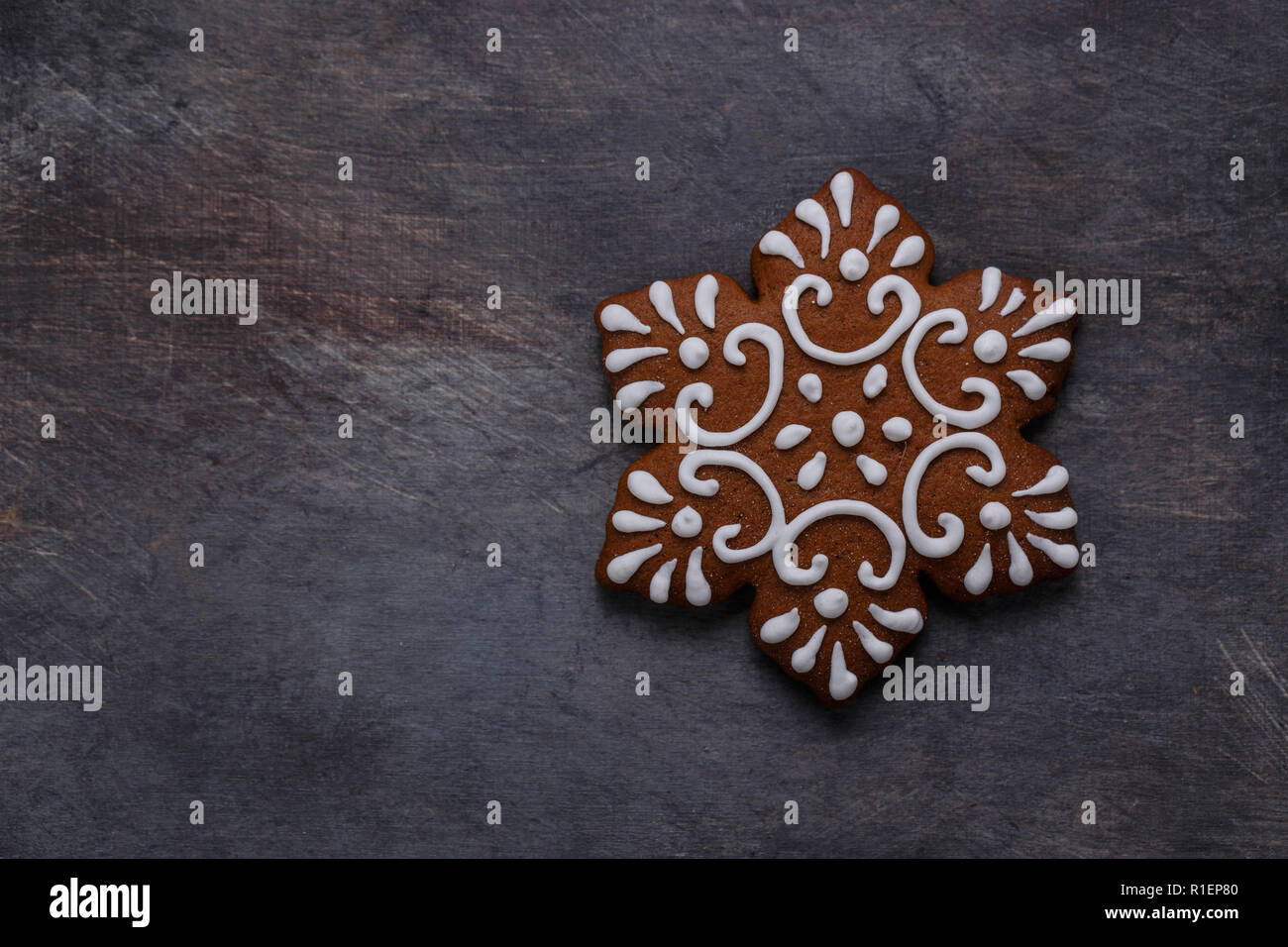 Gingerbread cookies snowflake on dark background, copyspace Stock Photo