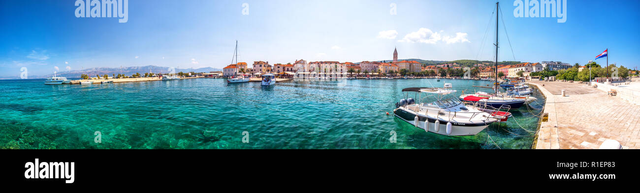 SUPETAR, CROATIA - August 8, 2018 - Seaside promenade and harbour in Supetar town on Brac island with palm trees and turquoise clear ocean water, Supe Stock Photo