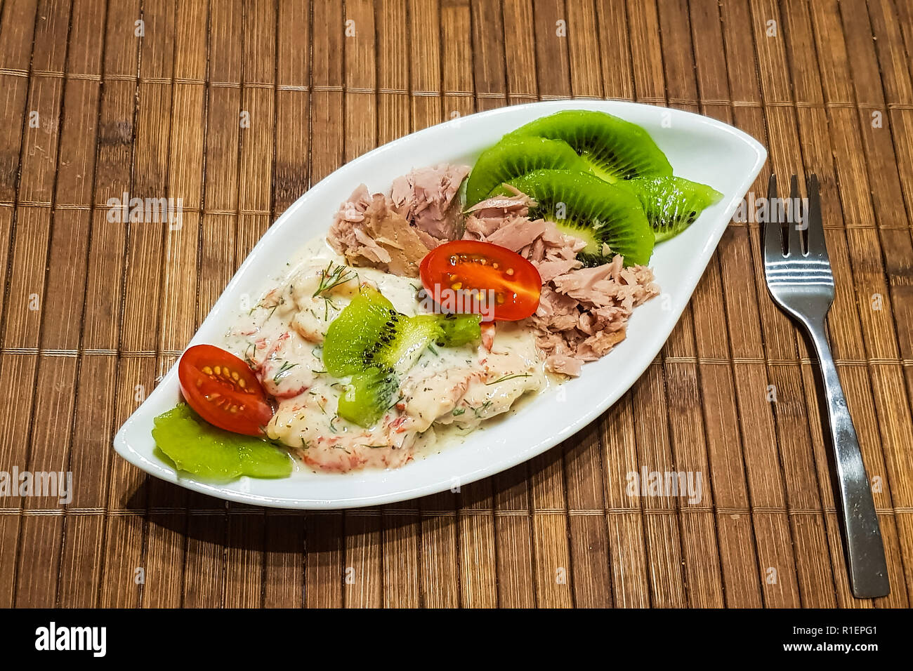 Healthy lowcarbohydrate food in small bowl, lunch with tomatoes, tuna