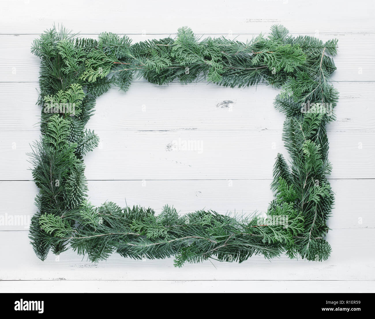 Christmas tree branches on wood background Stock Photo