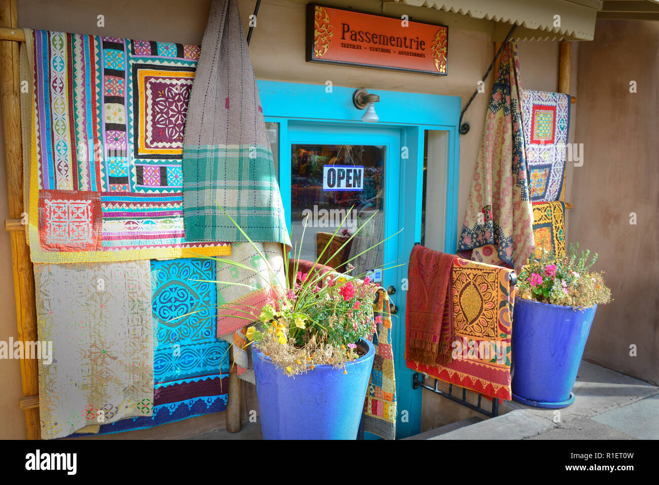 A textile shop displaying their wares outside their entrance in historic downtown Santa Fe, NM Stock Photo