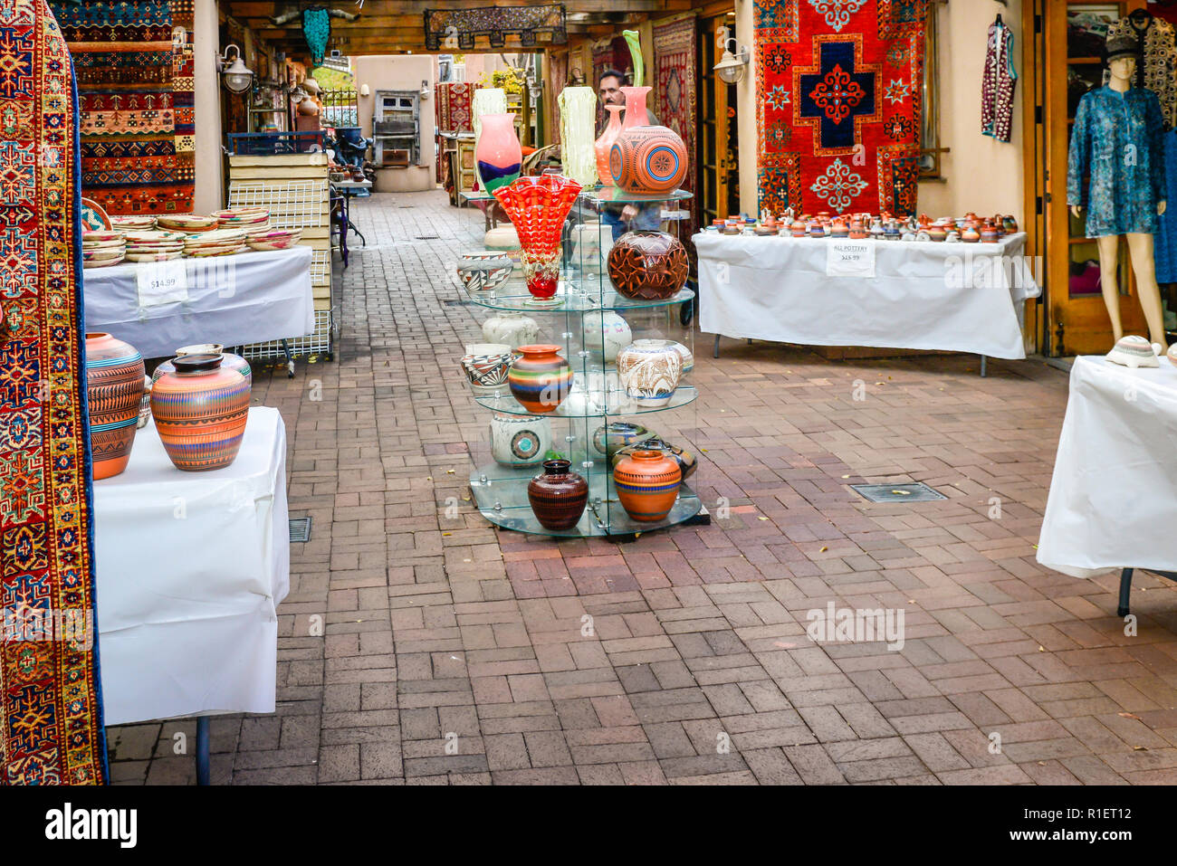One of many outdoor arcade style shopping areas selling pots and rugs in historic downtown Santa Fe, NM Stock Photo