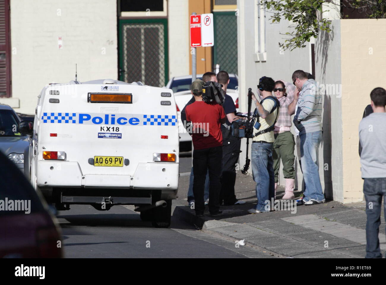 Police investigation in the housing commission projects of Woolloomooloo in Sydney, Australia, while a film crew records the activities for television. Stock Photo