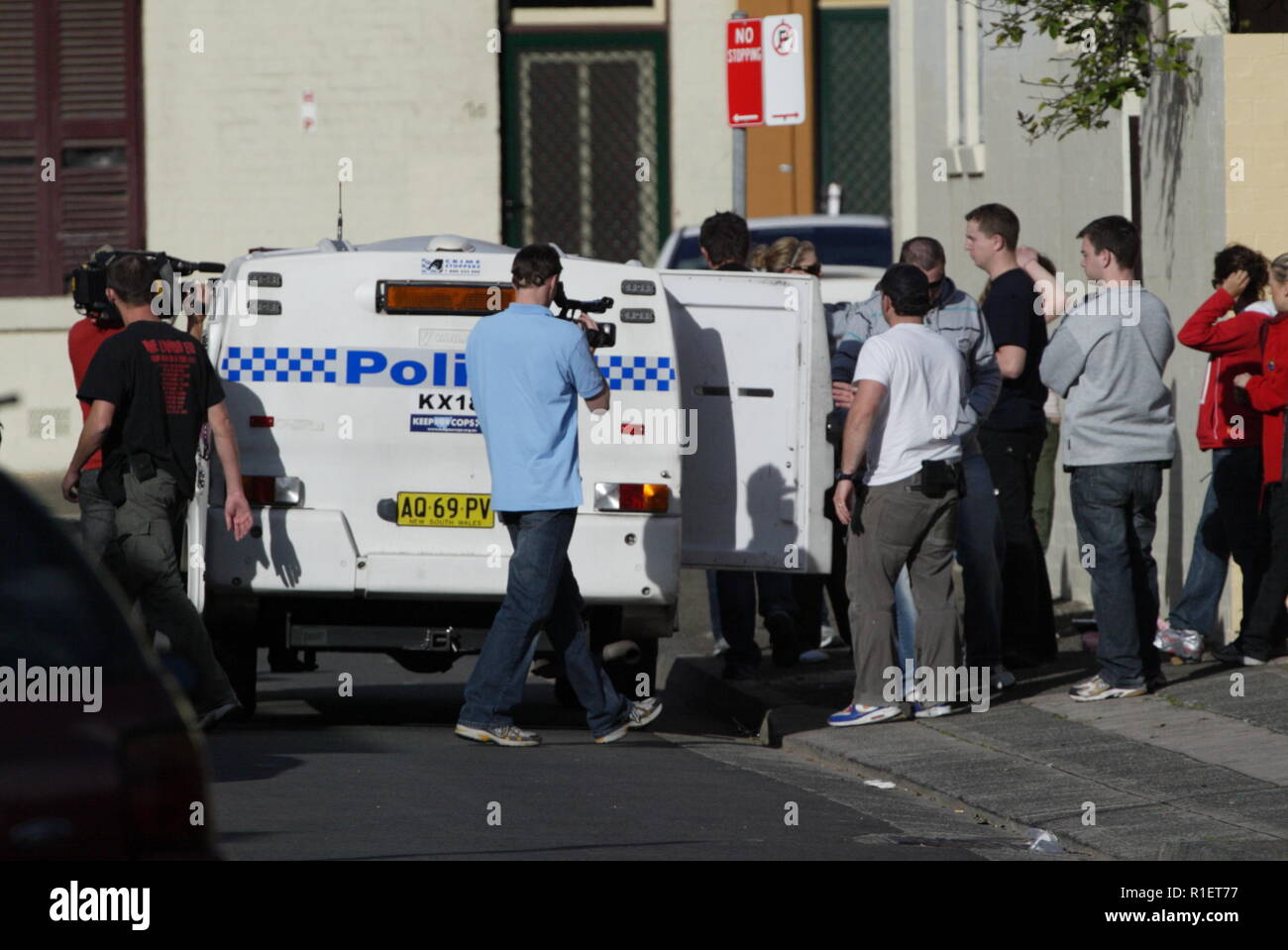 Police investigation in the housing commission projects of Woolloomooloo in Sydney, Australia, while a film crew records the activities for television. Stock Photo