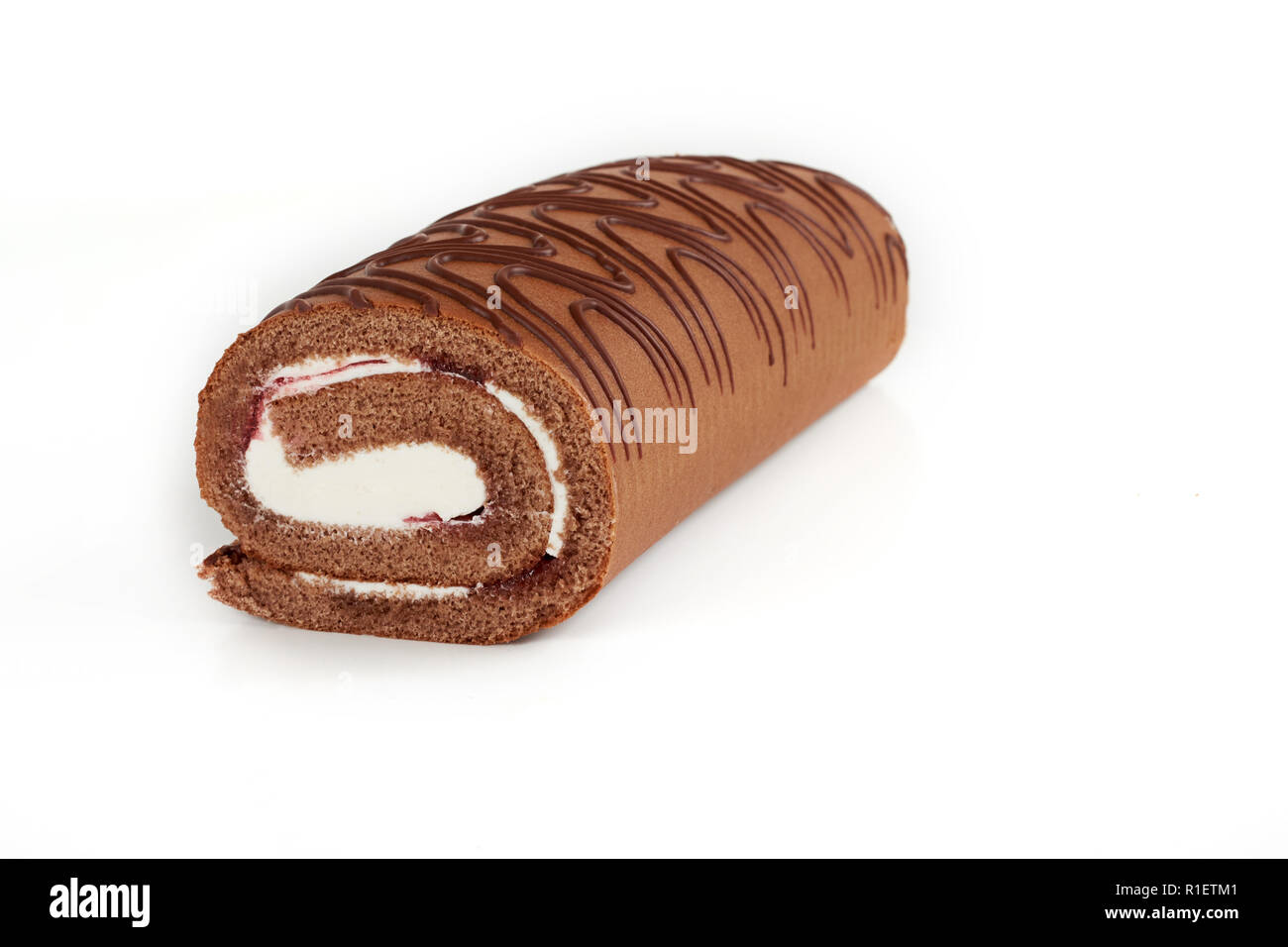 Chocolate biscuit roll cake isolated on white background Stock Photo