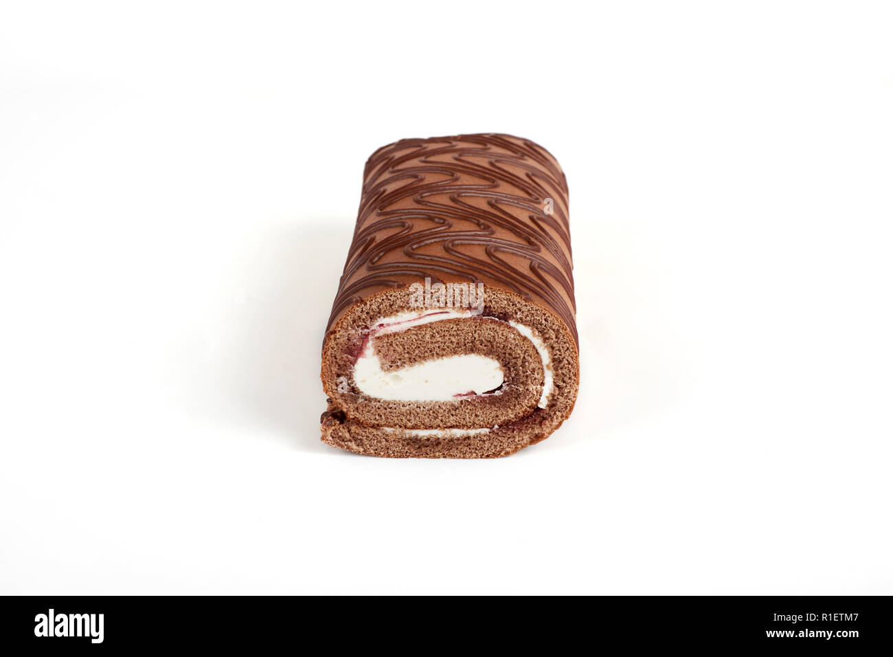 Chocolate biscuit roll cake isolated on white background Stock Photo