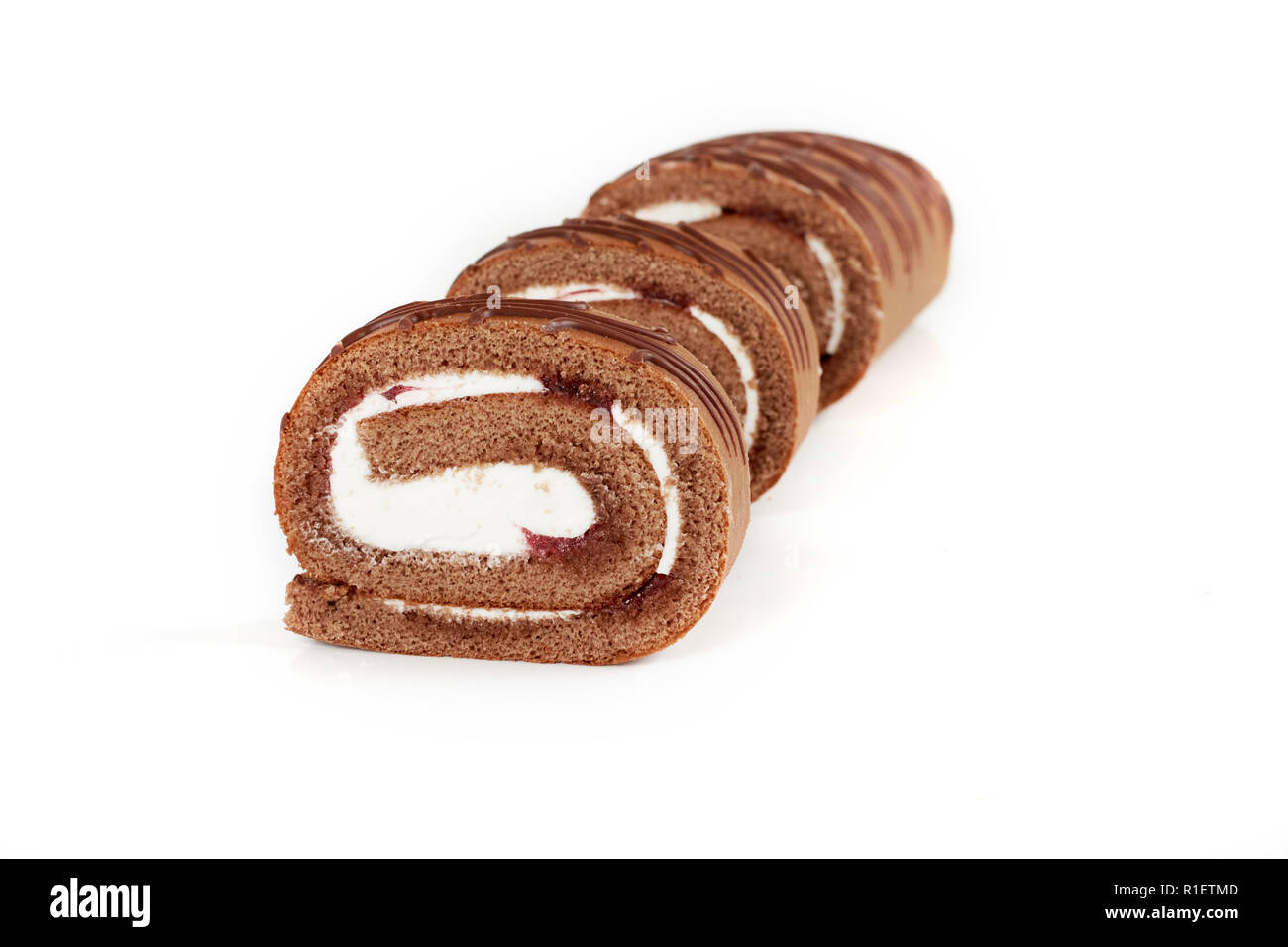 Chocolate biscuit roll cake isolated on white background Stock Photo