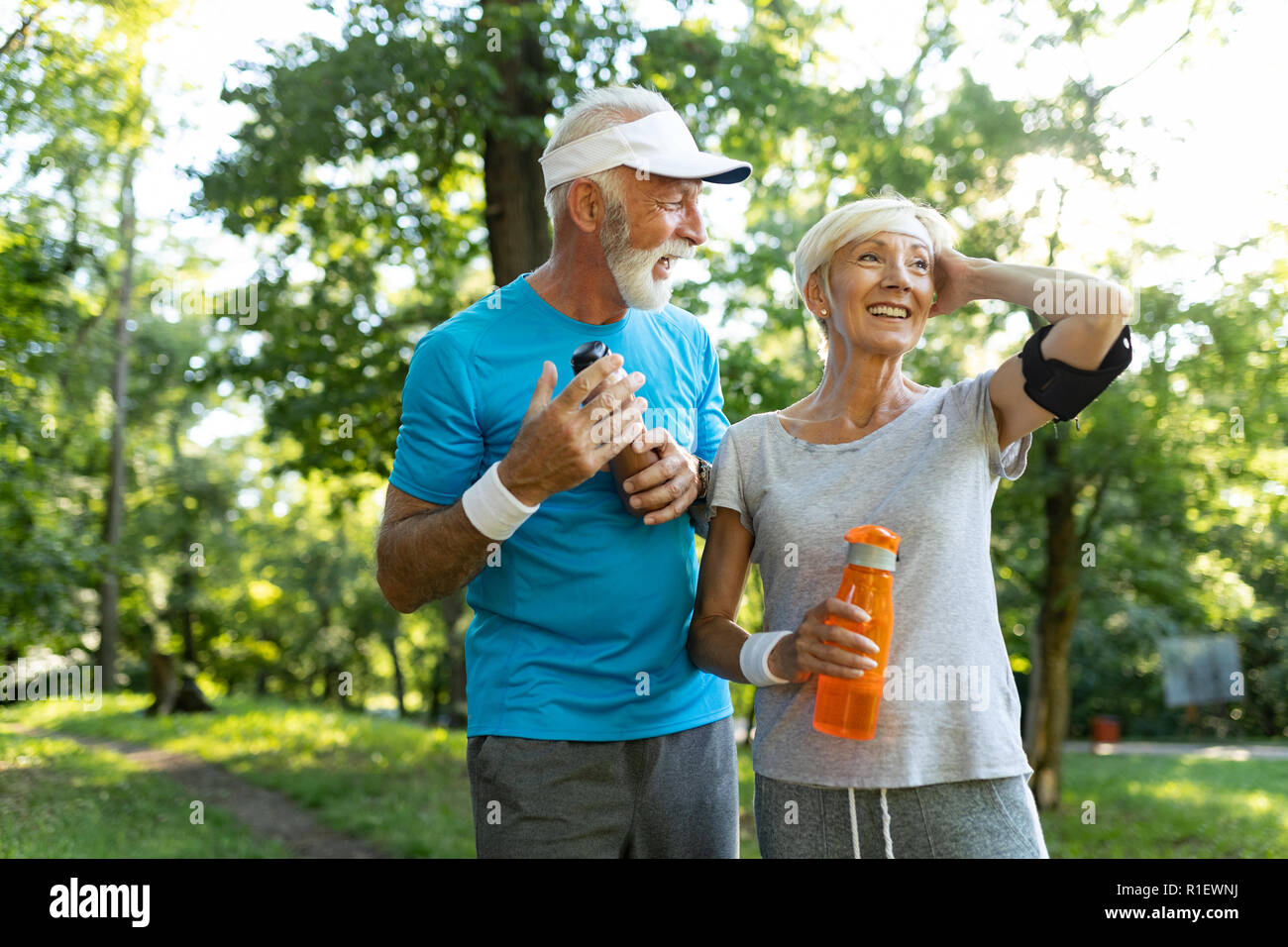 Mature couple jogging and running outdoors in nature Stock Photo - Alamy