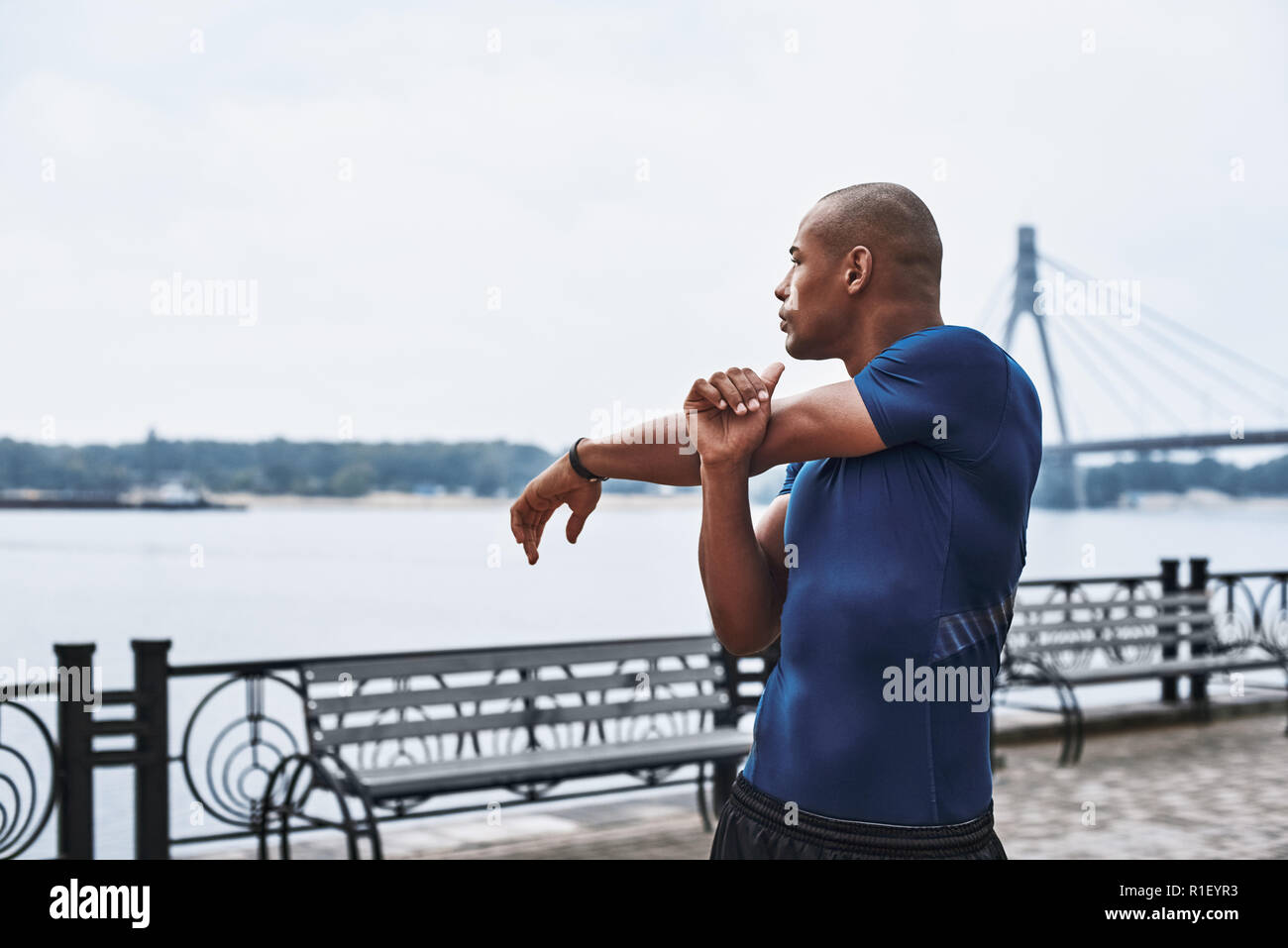 Sporty african man stretching arms hi-res stock photography and images ...