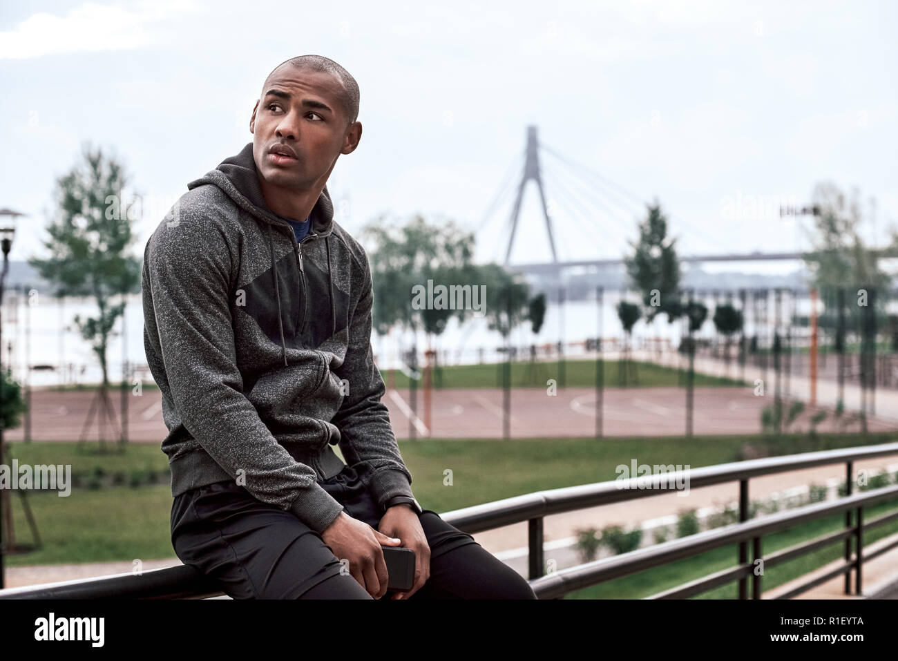 Relax after morning workout. Black handsome guy in sports clothes Stock Photo