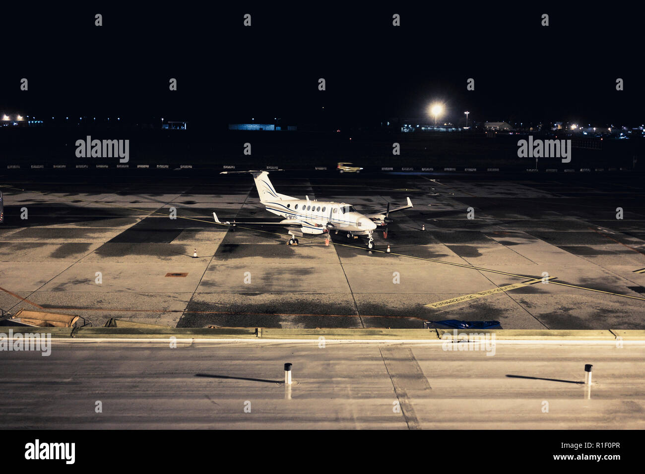 Airplane wait to start or just arrived. Private jet business company parked in the airport by night Stock Photo