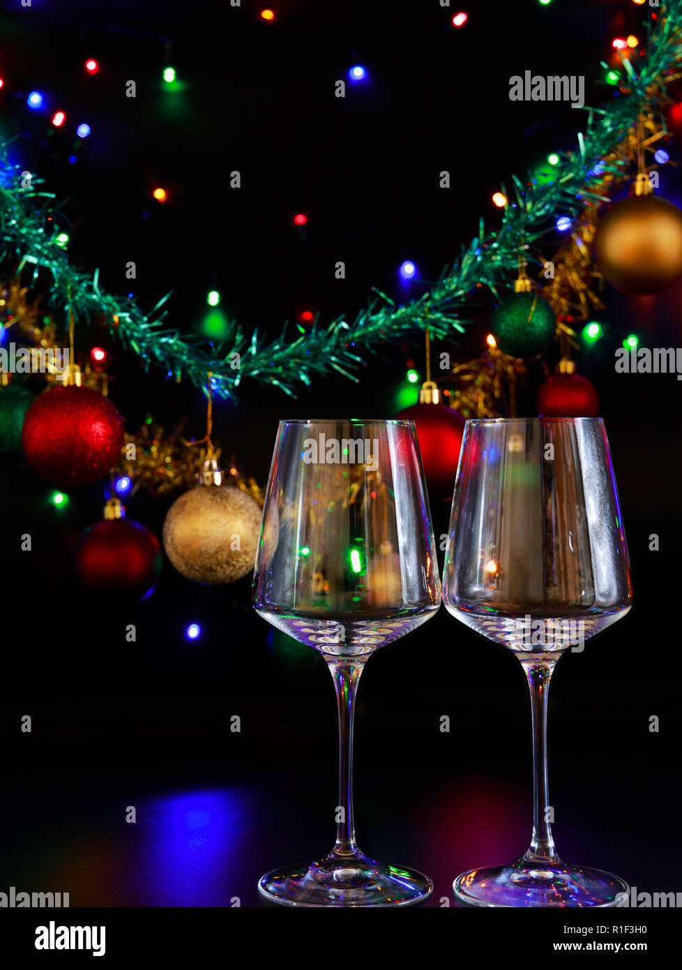 Two Wine Glasses Against A Background Of Colorful Christmas