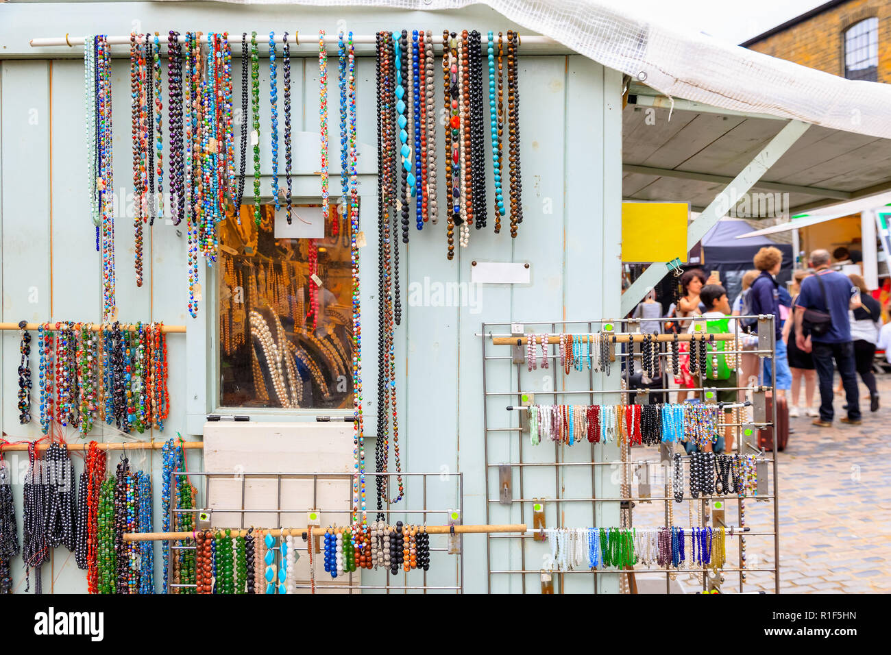 Assorted beaded necklaces and bracelets on display at Camden Market in