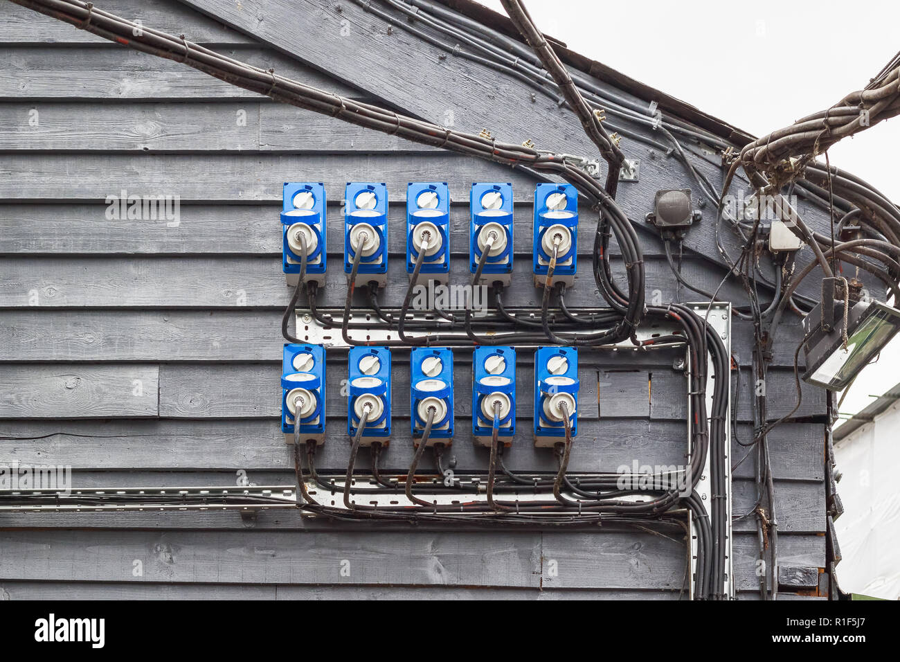 Outdoor power sockets with plugs in at Camden Market in London Stock Photo