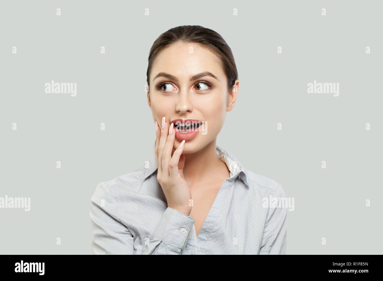 Happy surprised woman on white background Stock Photo - Alamy
