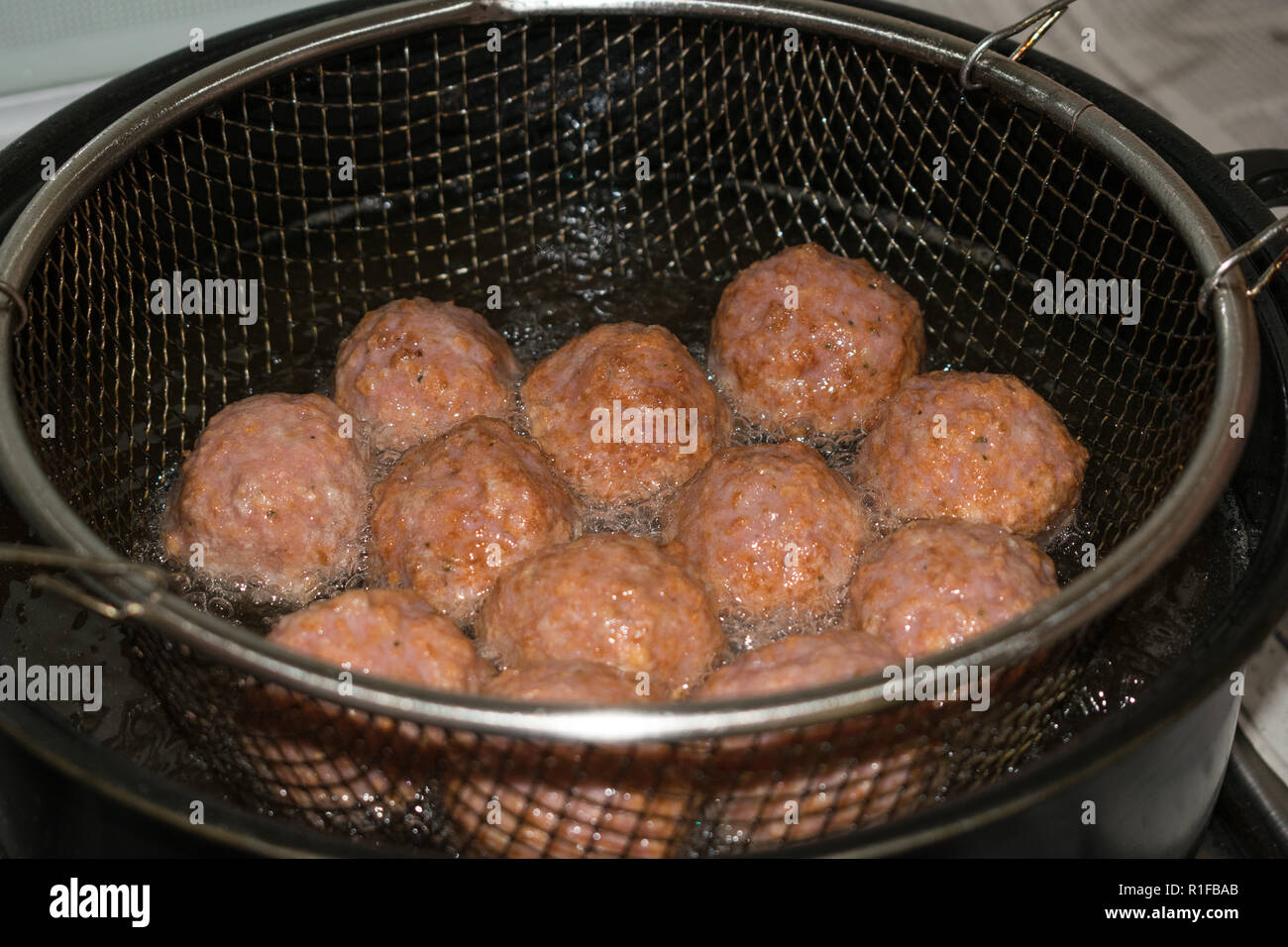 frying meatballs in fryer filled with oil Stock Photo Alamy