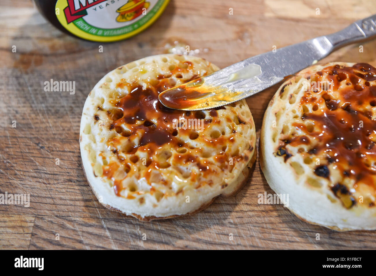 Toasted hot crumpets with butter and marmite  for breakfast Stock Photo