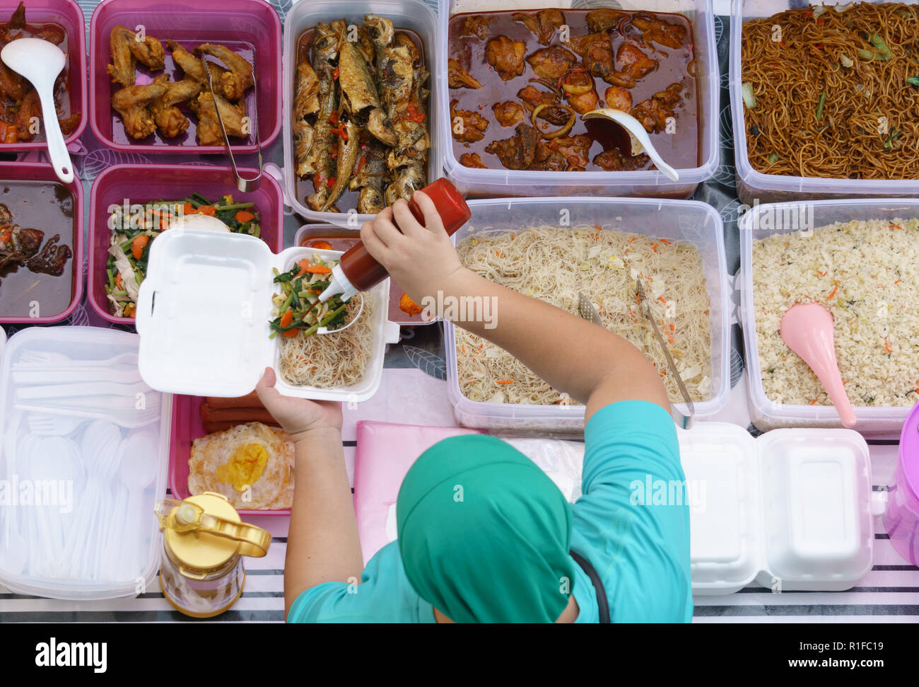 Variety of delicious Malaysian home cooked dishes sold at street market stall in Kota Kinabalu Sabah  from top angle view. Stock Photo