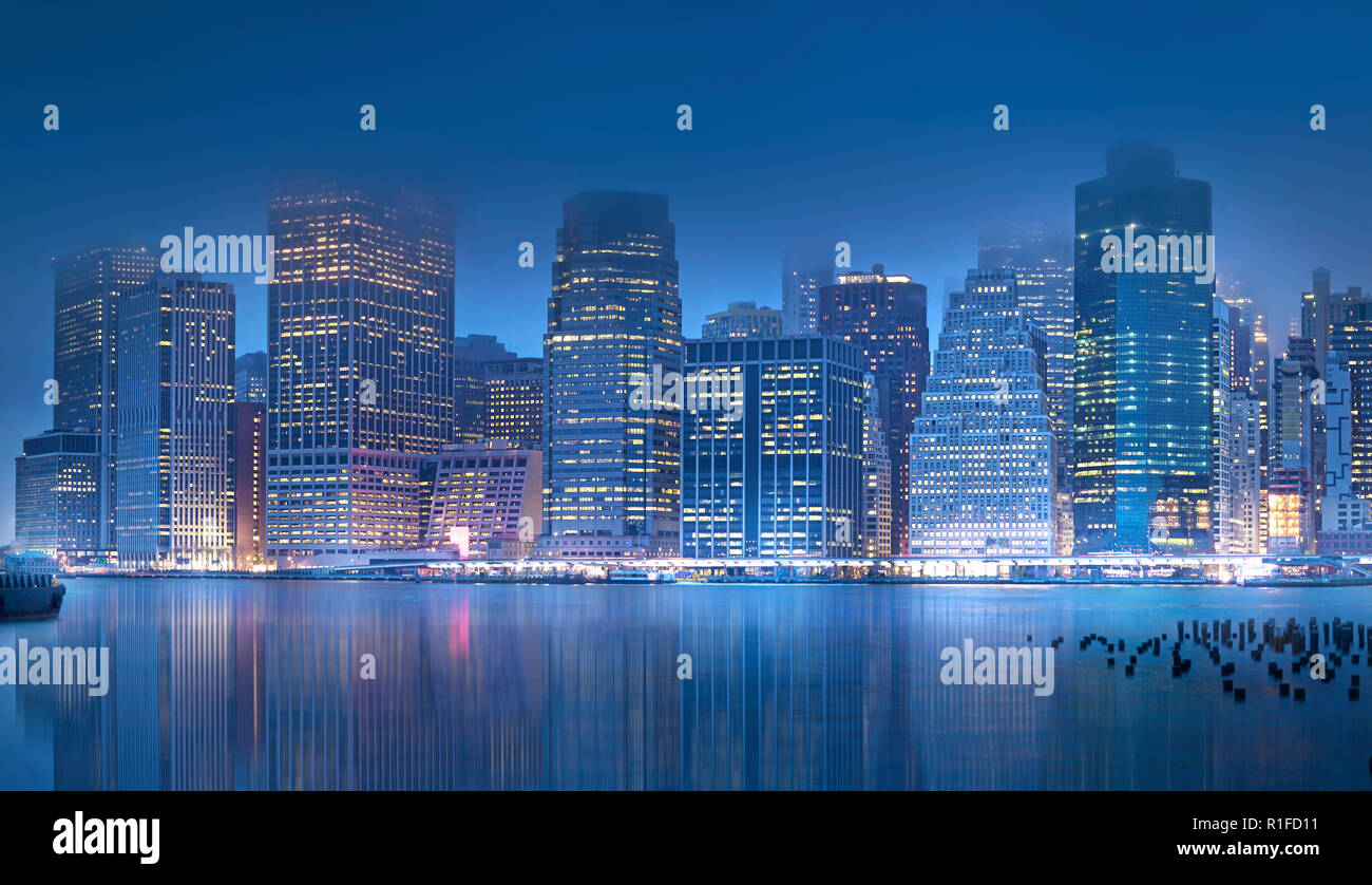 The beautiful skyline of New York City is reflected in the East River ...