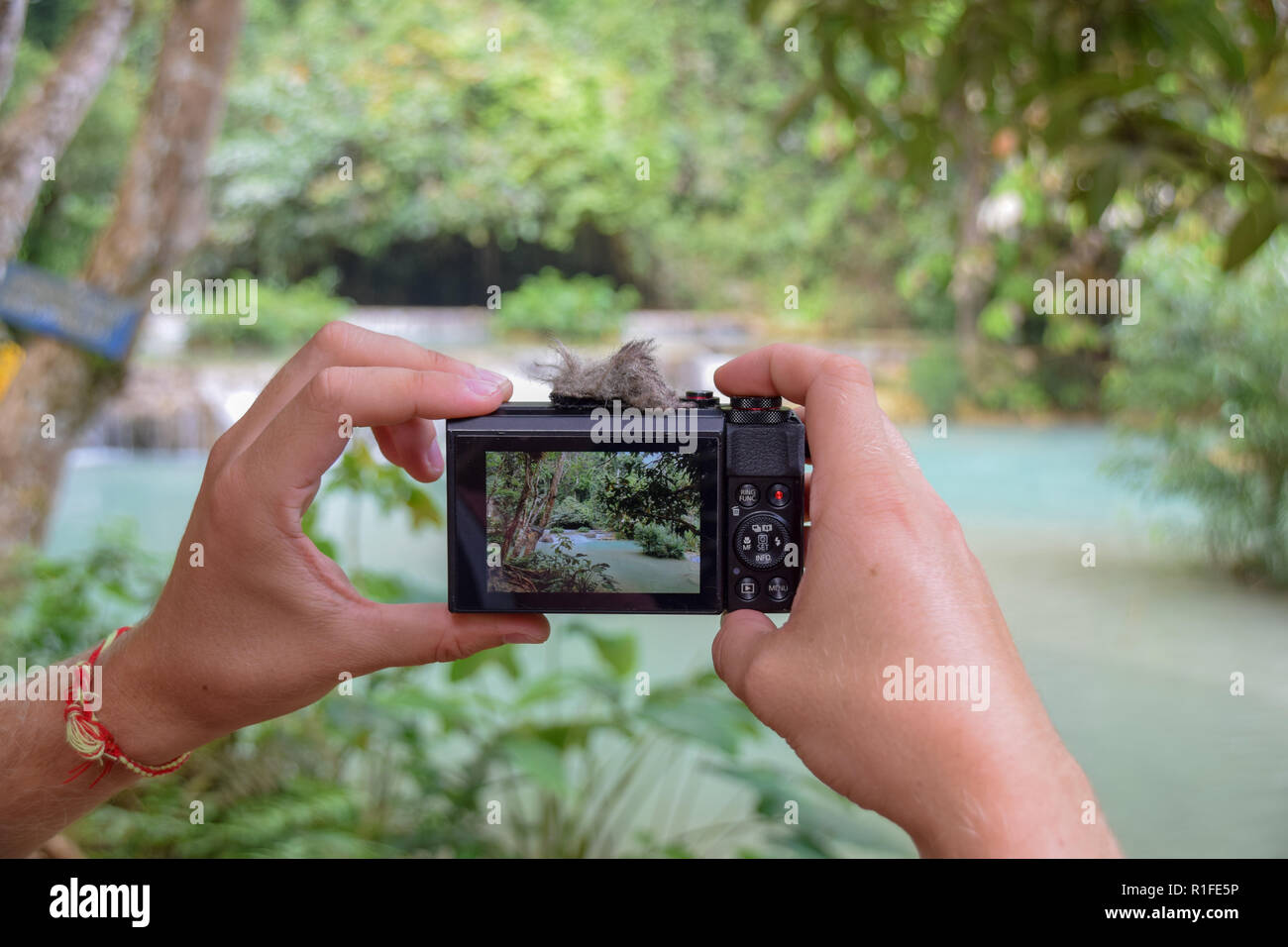 Taking a Picture with the Canon G7 at Kuang Si Waterfalls, Laos. Stock Photo