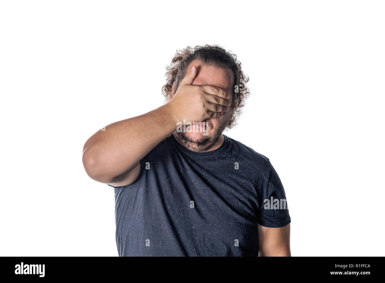 Portrait of a man covering his eyes with hands. See no evil concept ...