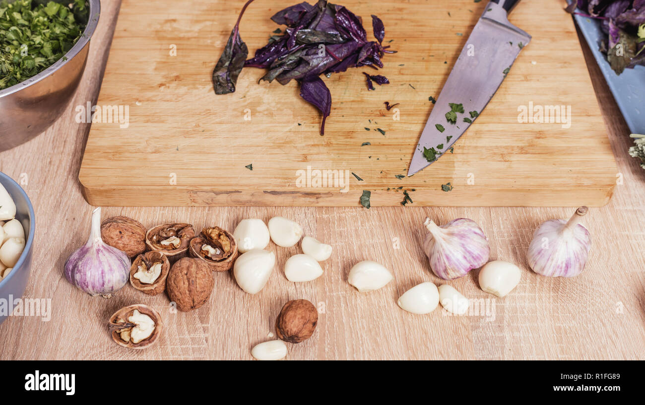 basil leaves and knife on a cutting board Stock Photo