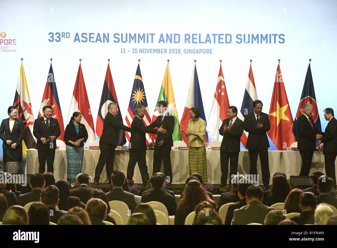 Singapore, Singapore. 12th Nov, 2018. Representatives attend the signing ceremony of ASEAN's agreement on e-commerce, in Singapore, on Nov. 12, 2018. Trade ministers of the Association of Southeast Asian Nations (ASEAN) member states signed an agreement on e-commerce on Monday, encouraging paperless trading between businesses and governments of the bloc to generate rapid and efficient transactions. Credit: Then Chih Wey/Xinhua/Alamy Live News Stock Photo