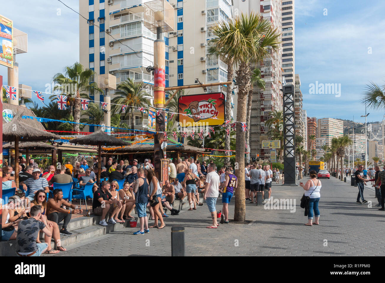 Benidorm, Costa Blanca, Spain 12th November 2018. The Tiki Beach Bar on Benidorm Levante Beach, a favourite hangout for British holidaymakers is still open despite recent reports that it was shutting down due to complaints about unruly behaviour. Staff were seen outside taking drinks off customers on the promenade and pouring them into plastic glasses. Boozy Brits have been blamed for anti-social behaviour at the popular beach front music bar. Credit: Mick Flynn/Alamy Live News Stock Photo