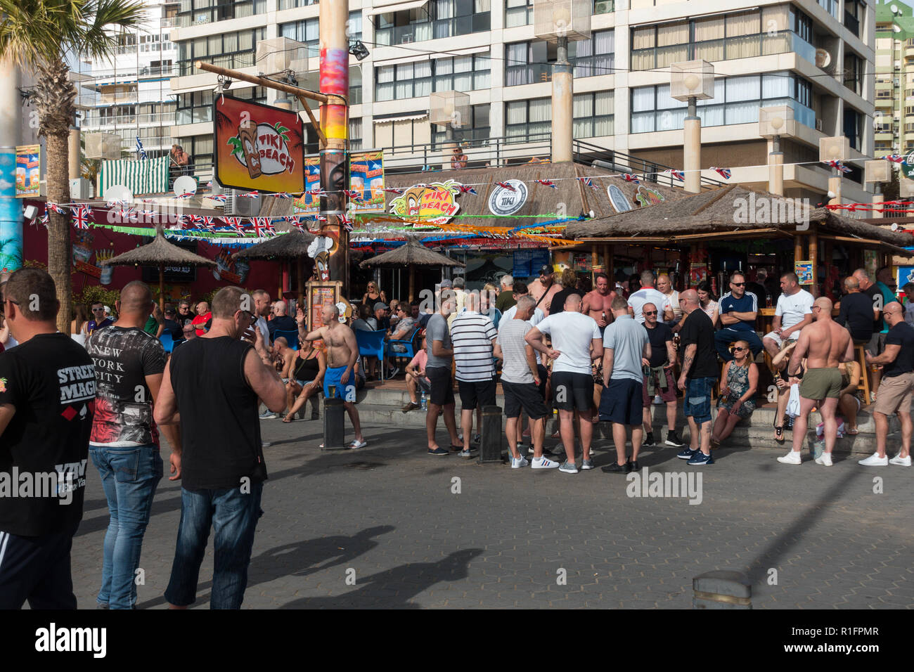 Benidorm, Costa Blanca, Spain 12th November 2018. The Tiki Beach Bar on Benidorm Levante Beach, a favourite hangout for British holidaymakers is still open despite recent reports that it was shutting down due to complaints about unruly behaviour. Staff were seen outside taking drinks off customers on the promenade and pouring them into plastic glasses. Boozy Brits have been blamed for anti-social behaviour at the popular beach front music bar. Credit: Mick Flynn/Alamy Live News Stock Photo
