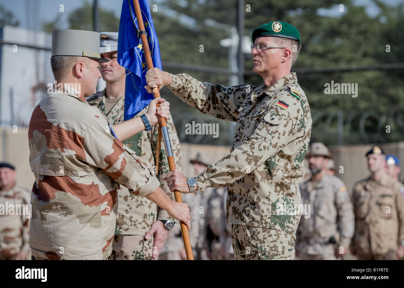Bamako, Mali. 12th Nov, 2018. Peter Mirow, Bundeswehr General, receives the troop flag of the EU training mission EUTM MLI from the French General Daniel Grammatico. Germany has taken over the leadership of the mission in Mali. Von der Leyen is in Africa for a three-day visit and also visits the soldiers of the Bundeswehr. Credit: Michael Kappeler/dpa/Alamy Live News Stock Photo