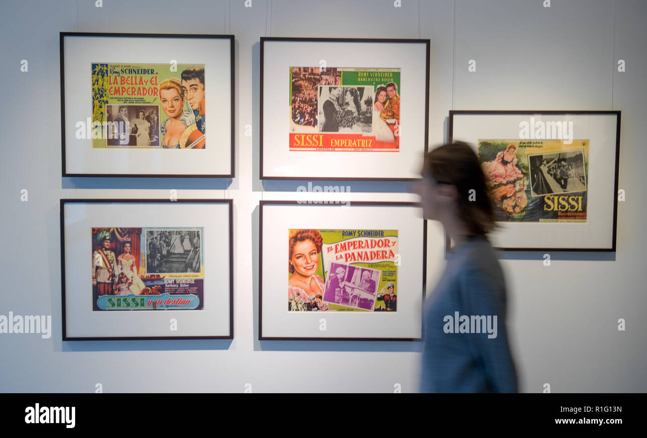 Hamburg, Germany. 12th Nov, 2018. A woman in the Fabrik der Künste in the Romy Schneider exhibition is looking at cinema posters with pictures of the deceased actress. The exhibition, which will take place from 14 November to 02 December 2018, features photos, magazine covers and cinema posters from Schneider's time from the private collection Joost. Credit: Axel Heimken/dpa/Alamy Live News Stock Photo