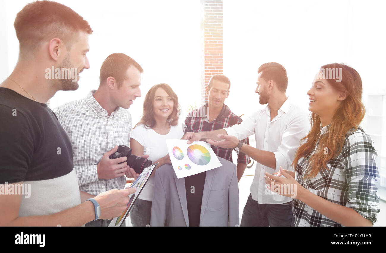 team of designers discussing the color palette Stock Photo - Alamy
