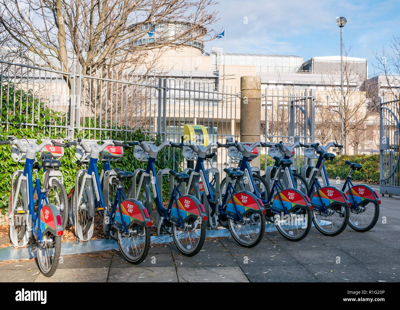 Rack of Just Eat rental bikes, at Scottish Government building, Victoria Quay, Leith, Edinburgh, Scotland, UK Stock Photo
