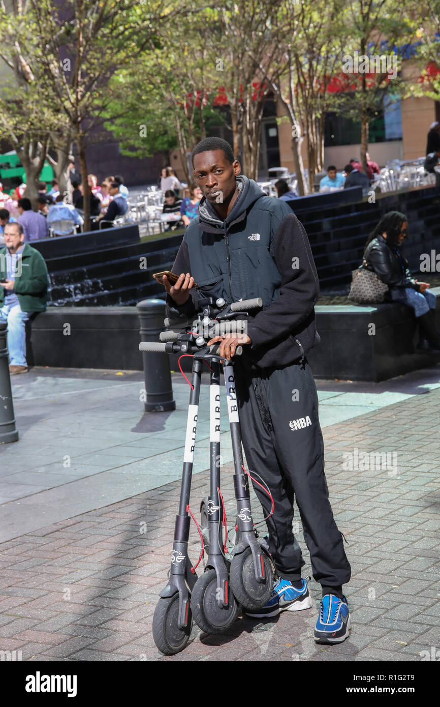 CHARLOTTE, NC, USA10/31/18 A man collects electric scooters to restock locations in uptown