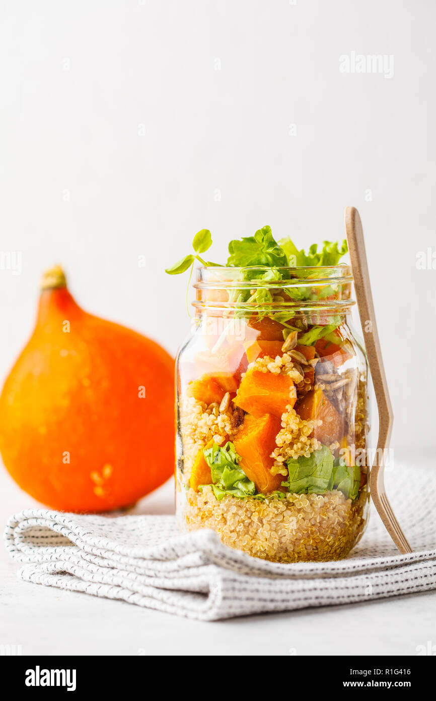 Pumpkin, quinoa salad in a jar on white background. Take away food, picnic food. Stock Photo