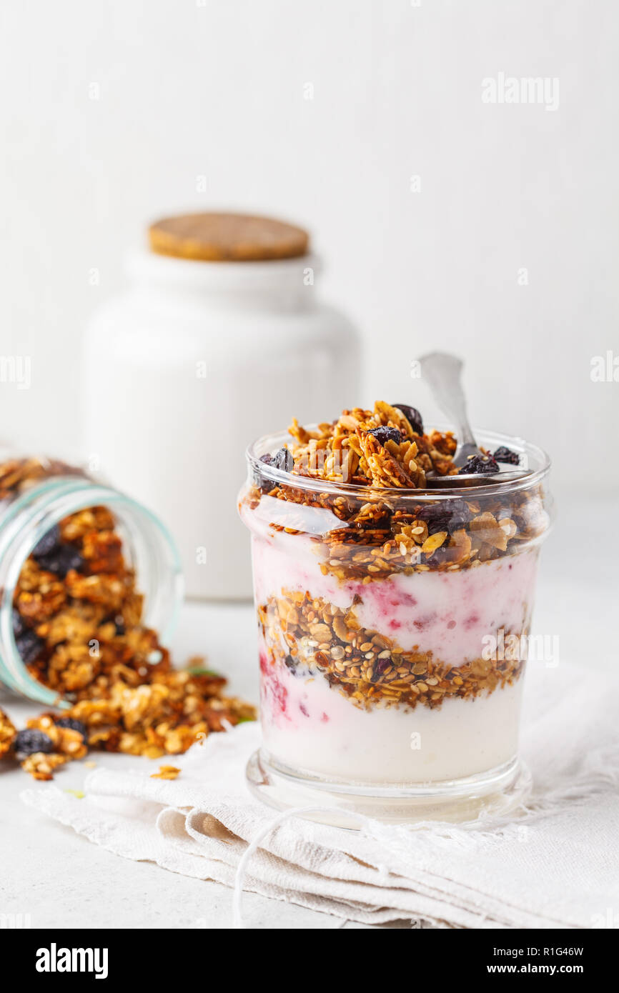 Baked granola, jam and yogurt healthy breakfast parfait in glass. Healthy detox food concept. Stock Photo