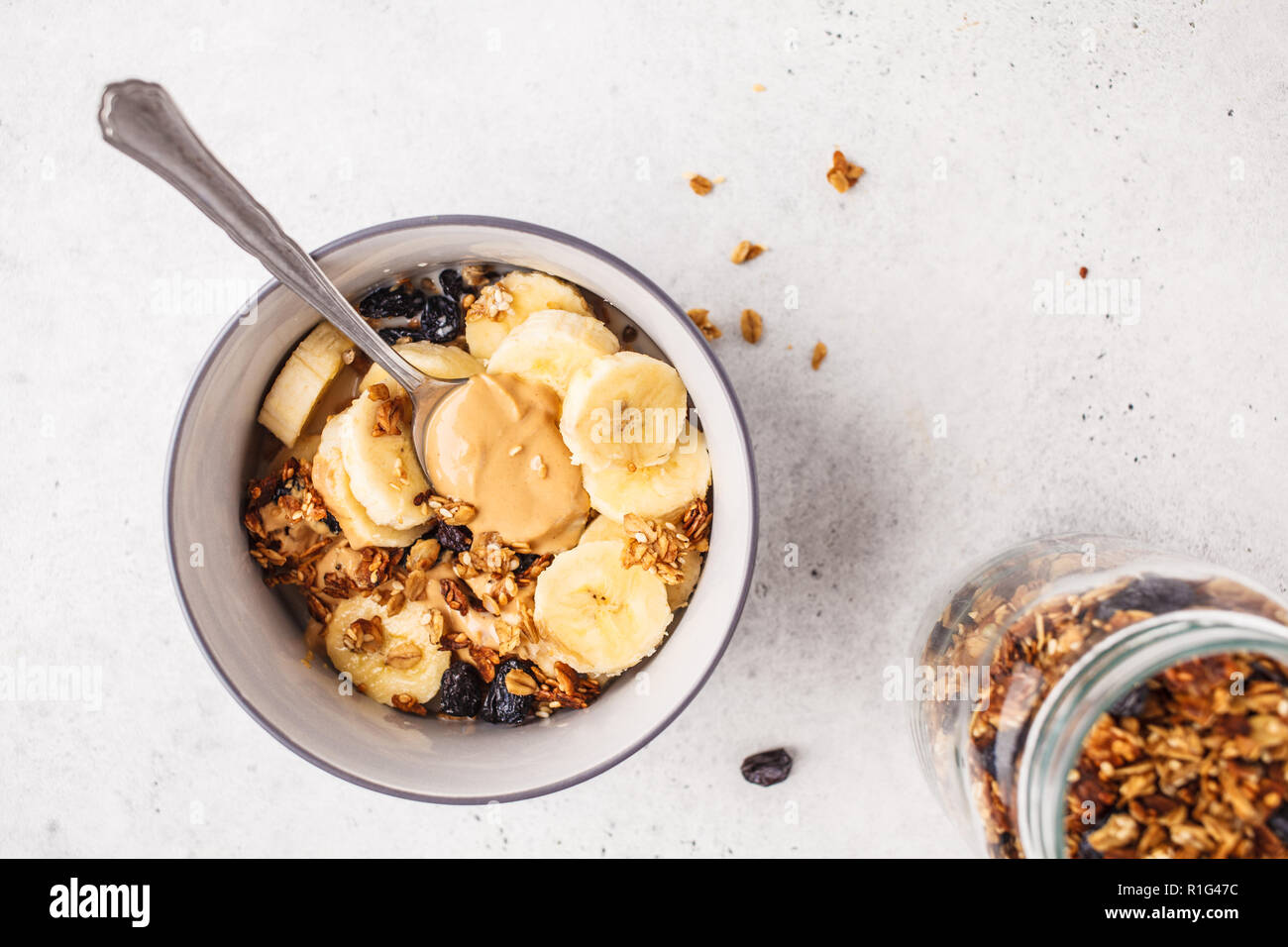 Baked granola with raisins, banana and peanut butter. Plant based diet