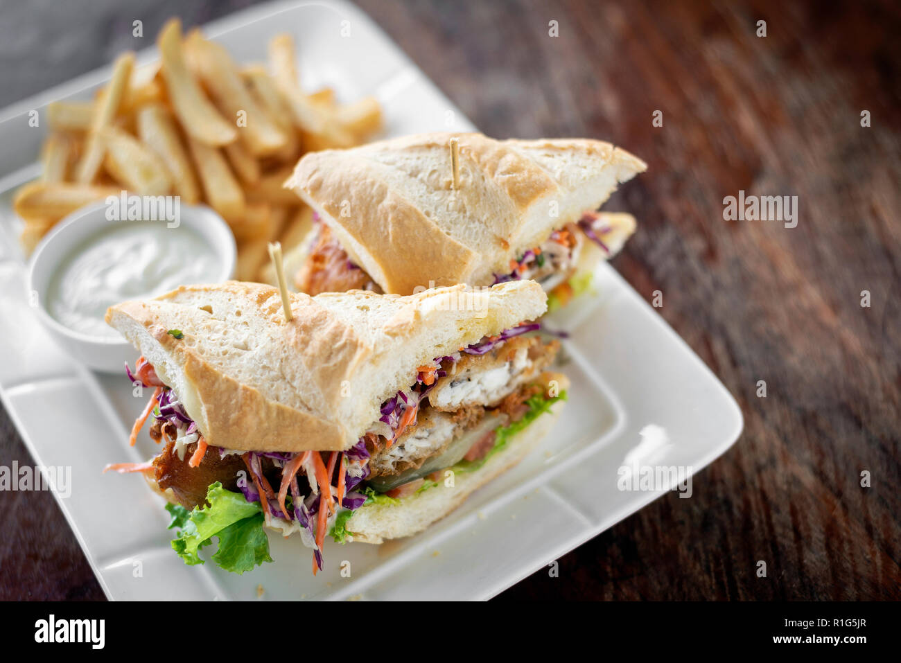 fried battered fresh fish fillet sandwich with coleslaw salad french