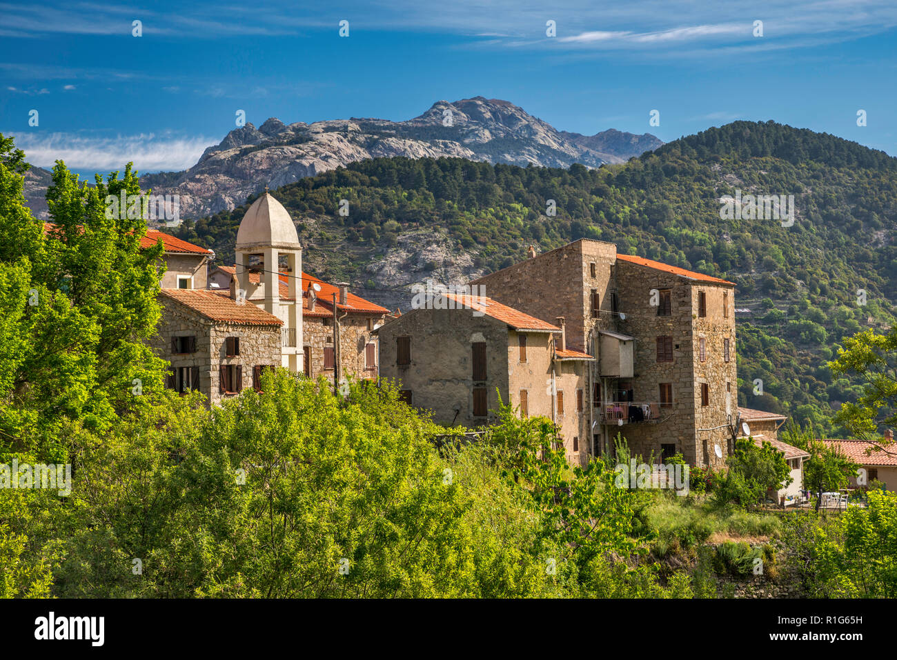 Hill town of Chidazzo over Gorges de Spelunca, Capo Ferolata massif in distance, Corse-du-Sud, Corsica, France Stock Photo