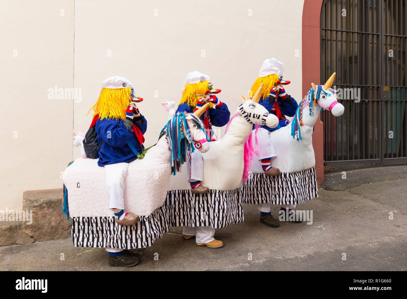 Basel carnival. Schluesselberg, Basel, Switzerland - February 21st, 2018. Portrait of three participants in cute unicorn costumes Stock Photo